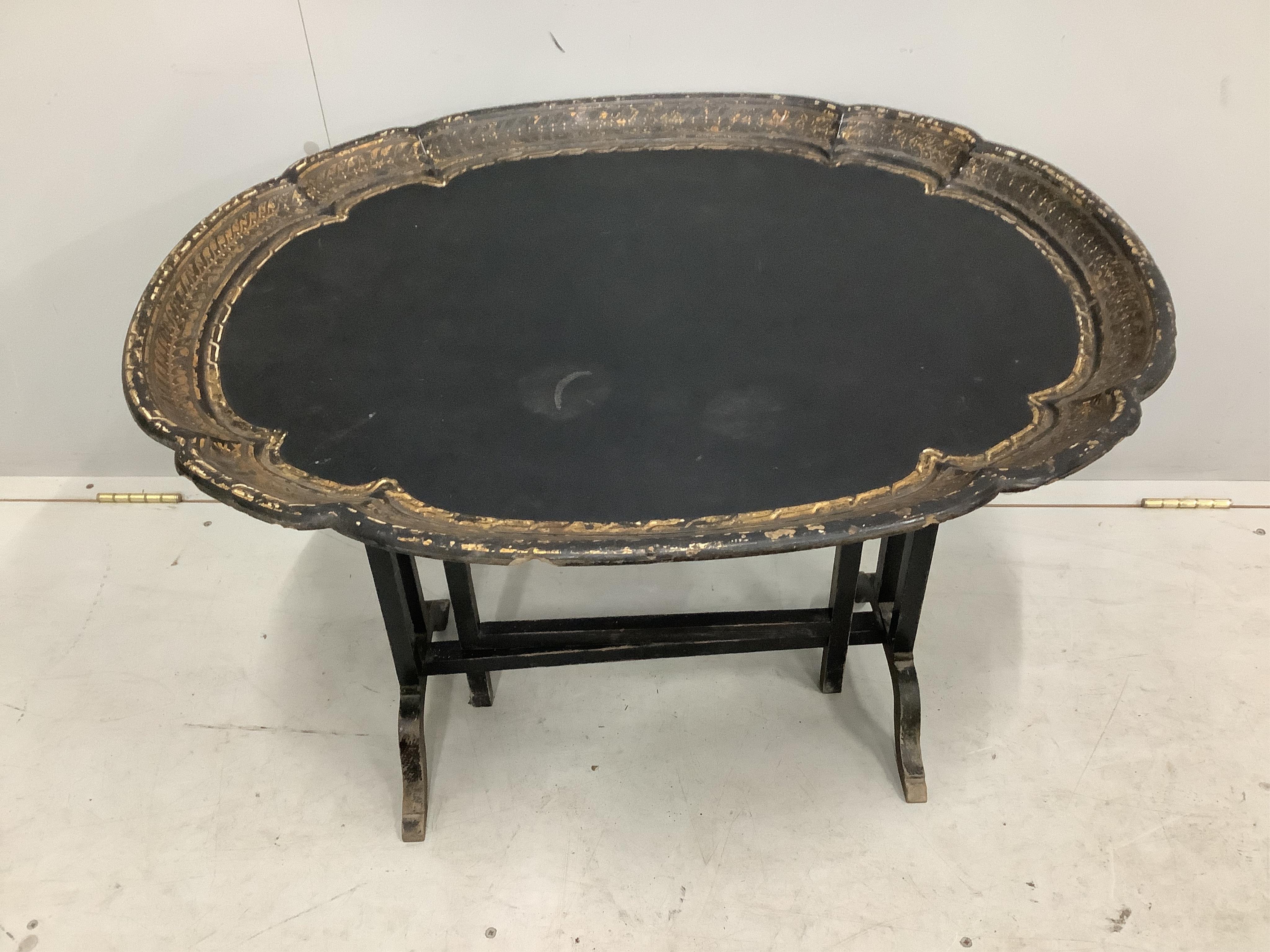 A Victorian oval papier mache folding occasional table, width 79cm, depth 64cm, height 54cm. Condition - fair